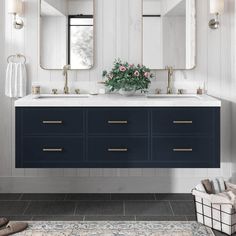 a white and blue bathroom with two mirrors above the sink, flowers on the counter