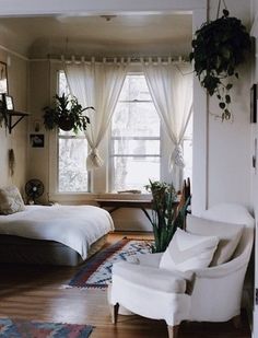 a pinter's view of a bedroom with two white chairs and a bed in the background