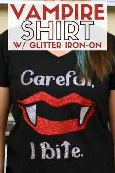 a girl wearing a vampire shirt with glitter on it