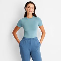 This Seamless Jersey Crop Top from A New Day™ in a solid colors offers easy pairing with a range of looks. Fashioned in a cropped length, it features a classic crewneck and a slim silhouette to give you a fitted look. The lightweight fabric with added stretch and a seamless design offers a more comfortable fit, and you can wear it with your choice of bottoms to create a range of versatile styles. . A New Day™: Style that goes wherever you do. Jersey Crop Top, Teal Shirt, Teal Top, High Neck Tank Top, Crop Blazer, Slim Fit Shorts, Baby T Shirt, A New Day, Teal Blue