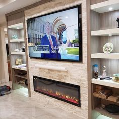 a flat screen tv mounted on the wall above a fireplace