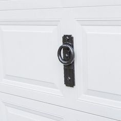 a close up of a white door with a black handle