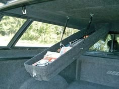 the back end of a car with its trunk open and magazines in it's compartment