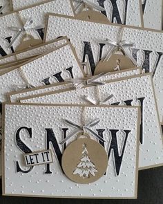 several christmas cards with tags hanging from them