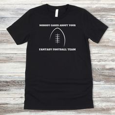 This Fantasy Football shirt makes the perfect gift for him whether it be for Father's Day, his birthday, or draft day.  All Fantasy Football lovers will appreciate it! This classic unisex jersey short sleeve tee fits like a well-loved favorite. Soft cotton and quality print make users fall in love with it over and over again. These t-shirts have-ribbed knit collars to bolster shaping. The shoulders have taping for better fit over time. Dual side seams hold the garment's shape for longer.  .: 100 Team Name T-shirt For Game Day, Game Day T-shirt With Team Name For Father's Day, Team Name T-shirt For Fan Events, Game Day Team Spirit T-shirt For Father's Day, Team Name T-shirt For Game Day On Father's Day, Football Season Fan Merchandise T-shirt, Black T-shirt For Game Day On Father's Day, Father's Day Team Spirit T-shirt With Crew Neck, Father's Day Team Spirit Crew Neck T-shirt