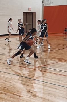 the girls are playing basketball on the court