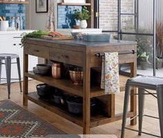 a kitchen island with pots and pans on it