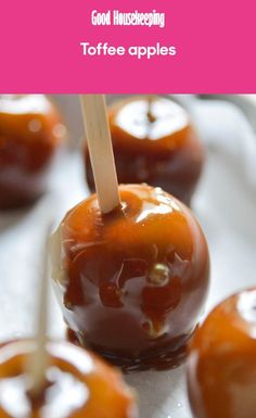 some caramel apples are sitting on a white surface with the words good house keeping toffee apples