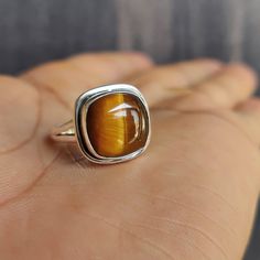 Cushion Tiger Eye Ring, Handmade Ring, 925 Solid Sterling Silver Ring, Women Ring, Tiger Eye Gemstone, Women Ring, Gift for Her Gemstone details:  Shape : Cushion Stone : Tiger Eye Metal : Solid silver Stone Color: Yellow Brown Add this beautiful Ring in your accessories to make you feel unique. This ring have 925 stamp and you will receive a ring like the one in the picture. You can choose any size you want from drop down menu. We Accept Custom Order and Bulk Order Also, Feel free to contact me for any queries regarding custom or bulk order. See more items on my shop: https://www.etsy.com/shop/RoyalJewelryHut Shipping detail:  Order are shipped within 2-3 business days by USPS or DHL e-commerce service. Estimate delivery time depend on the location and for USA it take 15-20 days approx. F Tiger Eye Engagement Ring, Tiger Eye Ring, Womens Tigers Eye Rings, Tiger Stone Ring, Tiger Eye Gemstone, Watermelon Tourmaline Ring, Tiger Eye Jewelry, Natural Gemstone Ring, London Blue Topaz Ring