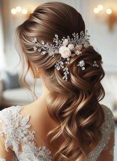 a woman with long hair and flowers in her hair is wearing a wedding hairstyle