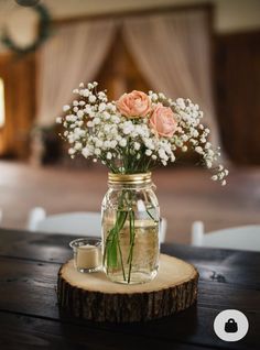 flowers in a mason jar sitting on a table