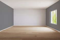 an empty room with wood floors and white walls