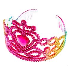 a pink tiara with beads and a heart on it's side, sitting in front of a white background