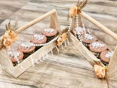 two wooden boxes filled with cupcakes on top of a table