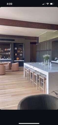 an open kitchen and living room with wooden floors