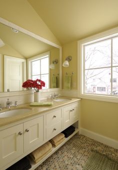 a bathroom with two sinks and a large mirror