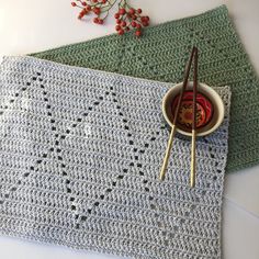 two crocheted placemats with chopsticks on one and a bowl of food in the other