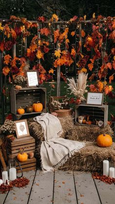 an outdoor area with hay bales and pumpkins