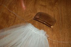 there is a comb and tulle on the floor