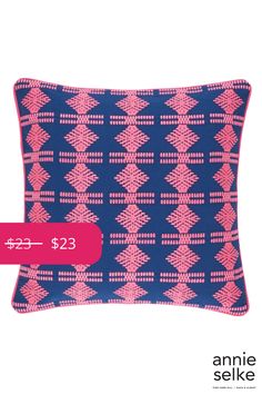 a blue and pink pillow with a red tag on it that says $ 23 in japanese