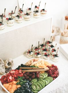 a platter filled with lots of different types of food on top of a table