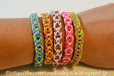 several different colored bracelets on someone's arm