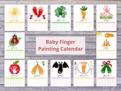 the baby finger painting calendar is displayed on a wooden table with various pictures and words