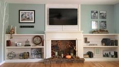 a living room filled with furniture and a flat screen tv mounted on the wall above a fire place