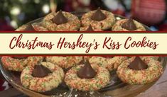 christmas hershey's kiss cookies in a glass bowl on a table with holiday decorations