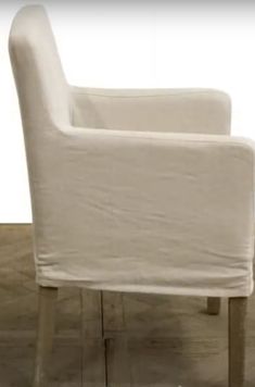 a white chair sitting on top of a wooden floor