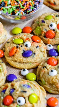 monster cookies with candy eyes and m & m candies all over them on a table