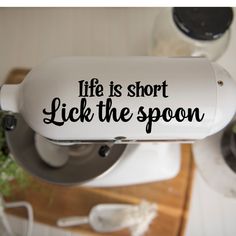 a sticker that says life is short lick the spoon on top of a blender