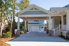 a large house with two garages in front of it