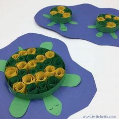 two paper plates with rolled up flowers in the shape of turtles