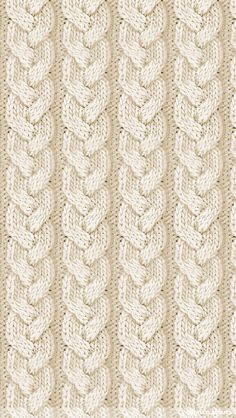 a knitted blanket with braiding on the bottom and sides, in beige tones