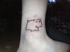 a small pig tattoo on the ankle