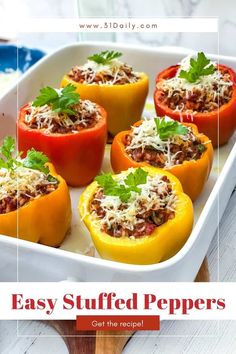 stuffed bell peppers in a baking dish with parmesan cheese and herbs on top