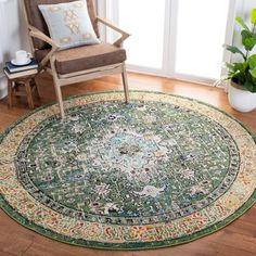 a chair sitting on top of a hard wood floor next to a large green rug