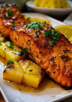 grilled salmon and pineapples on a white plate