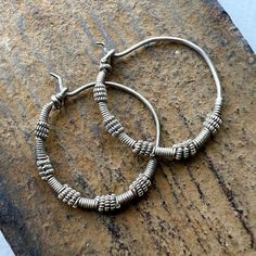 A pair of old silver Hoop earring from Afghanistan - Kuchi people. 28mm  wide - 1 1/8" inches  2mm wire through hole - thicker than Western earwires. 5.8 grams Adjustable Spiral Jewelry With Oxidized Finish, Adjustable Silver Hoop Earrings, Silver Adjustable Hoop Earrings, Adjustable Sterling Silver Hoop Earrings With Ear Wire, Artisan Spiral Nickel Free Jewelry, Traditional Metal Hoop Earrings, Artisan Small Hoop Sterling Silver Jewelry, Adjustable Nickel-free Sterling Silver Hoop Earrings, Traditional Nickel-free Spiral Jewelry