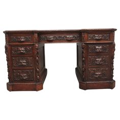 an antique wooden desk with carved carvings on the top and bottom, against a white background