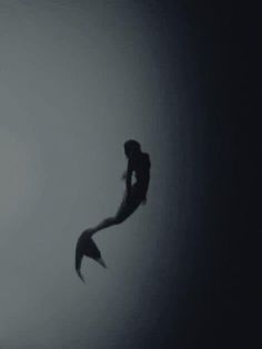 the silhouette of a woman is flying through the air