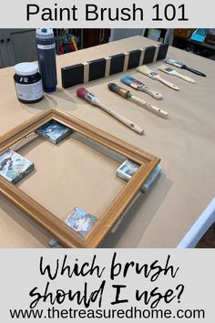 an easel with paint brushes and other art supplies on it, sitting on top of a table