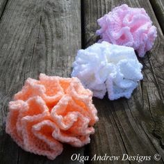 three crocheted hair scrunffs sitting on top of a wooden table