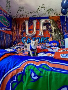 a bed room with a neatly made bed and decorations on the wall above it that says uf gators