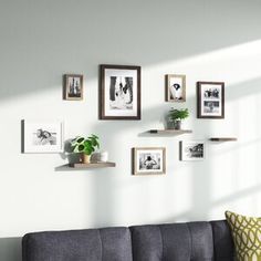 a living room filled with furniture and pictures on the wall