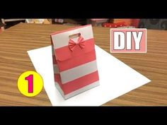 an open gift bag sitting on top of a table next to a sign that says diy