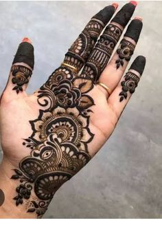 the hand is decorated with black henna