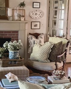 a living room filled with furniture and a fire place covered in pillows next to a fireplace