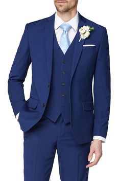 a man in a blue suit with a flower on his lapel